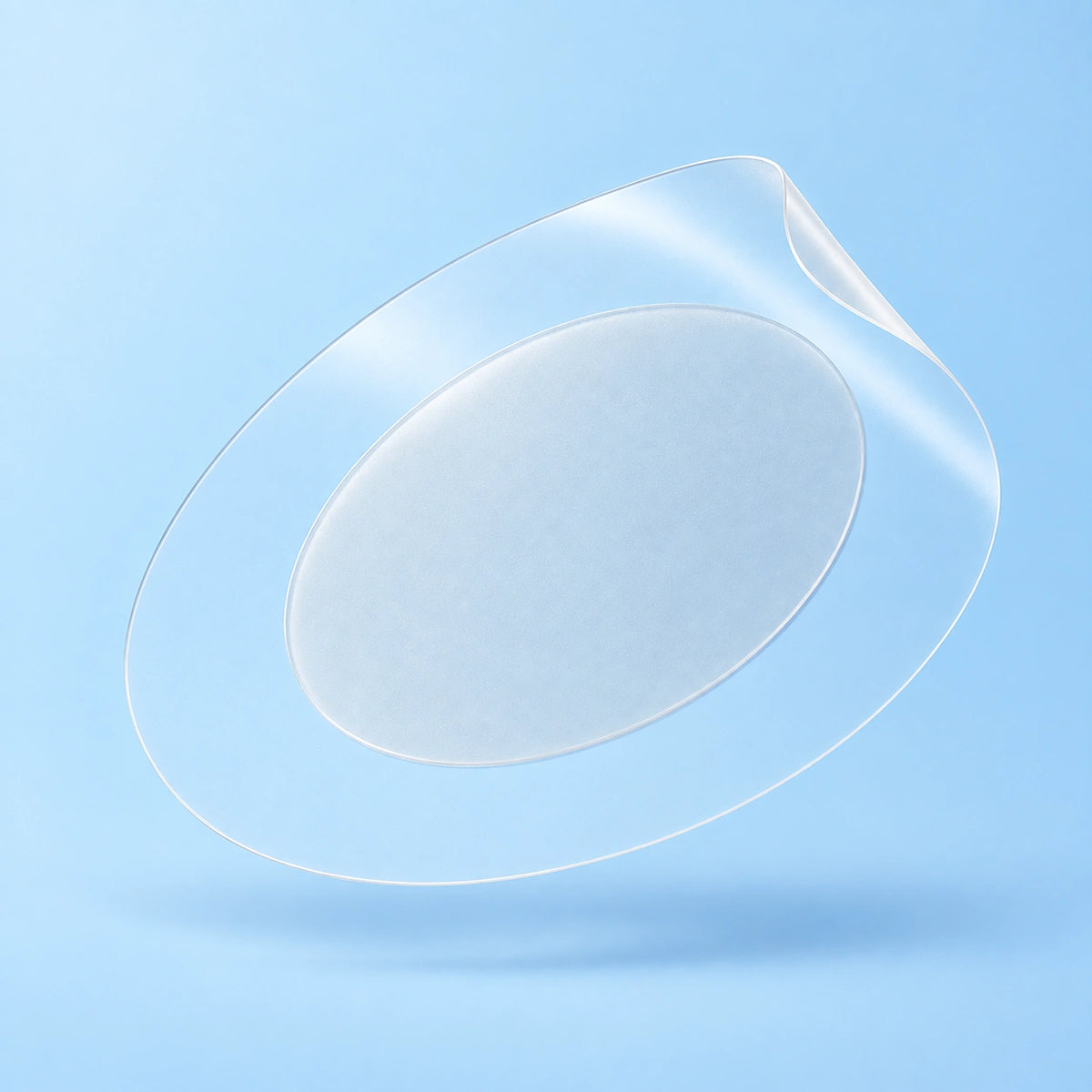 Magnified NoTrace patch floating at an angle, with a thin lifted edge, a clearly defined taper and a softly matte center.